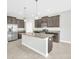 Modern kitchen with stainless steel appliances, granite countertops, and a spacious center island at 1028 Oliveto Verdi Ct, Brandon, FL 33511