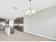 A kitchen with stainless steel appliances, a center island, and a chandelier above the eating area at 1028 Oliveto Verdi Ct, Brandon, FL 33511
