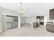 Open-concept living space with sliding glass doors to the patio, tile floors, and a large kitchen at 1028 Oliveto Verdi Ct, Brandon, FL 33511