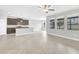 Open-concept living room with tile floors, lots of windows, and a view to the kitchen at 1028 Oliveto Verdi Ct, Brandon, FL 33511