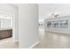 Bright open-concept living space with neutral tile flooring and a view to the connected bathroom at 1028 Oliveto Verdi Ct, Brandon, FL 33511