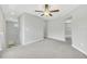 Loft area featuring neutral walls, gray carpet, ceiling fan, and natural light at 1028 Oliveto Verdi Ct, Brandon, FL 33511
