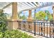 Community pool deck with decorative pergola and wrought iron railing offering serene views at 1028 Oliveto Verdi Ct, Brandon, FL 33511