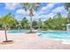 Spacious community pool area with lounge chairs and palm trees creating a relaxing atmosphere at 1028 Oliveto Verdi Ct, Brandon, FL 33511
