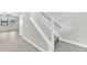 Carpeted staircase with white wood trim and handrail leading to the upper level of the home at 1028 Oliveto Verdi Ct, Brandon, FL 33511