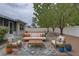 This backyard is staged with outdoor furniture, a fire pit area, gravel ground cover and some small shrubbery at 11188 64Th Ter, Seminole, FL 33772