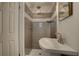 Bathroom featuring a vessel sink, tiled shower, and modern lighting at 11188 64Th Ter, Seminole, FL 33772