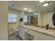 Bathroom featuring a double sink vanity, granite countertop, and tiled shower at 11188 64Th Ter, Seminole, FL 33772