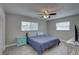 Cozy bedroom features a ceiling fan, light gray walls, and plank flooring at 11188 64Th Ter, Seminole, FL 33772