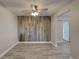 Cozy dining room features wood accent wall, hardwood floors, and modern ceiling fan at 11188 64Th Ter, Seminole, FL 33772