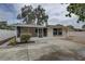 A home with a screened patio, neutral siding, and a concrete driveway offering a welcoming and functional outdoor space at 11188 64Th Ter, Seminole, FL 33772