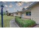 Close-up of the home's front entrance, highlighting the well-kept lawn, walkway, and tidy landscaping at 11188 64Th Ter, Seminole, FL 33772