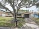 Charming single-story home with a well-manicured lawn and mature tree at 11188 64Th Ter, Seminole, FL 33772