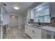 Bright kitchen features white cabinets, stainless steel appliances, and granite countertops at 11188 64Th Ter, Seminole, FL 33772