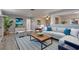 Bright living room featuring contemporary decor, stylish furniture, and wood-look flooring at 11188 64Th Ter, Seminole, FL 33772