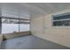 A screened patio featuring concrete flooring and views of the backyard with a white privacy fence at 11188 64Th Ter, Seminole, FL 33772