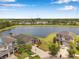 Aerial view of neighborhood homes with pond view at 11878 Thicket Wood Dr, Riverview, FL 33579