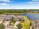 Stunning aerial perspective showcasing a home nestled by a tranquil lake within a picturesque neighborhood at 11878 Thicket Wood Dr, Riverview, FL 33579