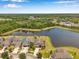 Beautiful aerial view showcases this home's prime location and serene lakefront property, with lush greenery at 11878 Thicket Wood Dr, Riverview, FL 33579