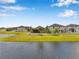 View of backyard and pond from across the water at 11878 Thicket Wood Dr, Riverview, FL 33579