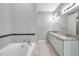 Bathroom featuring soaking tub, double vanity with granite countertop, modern fixtures, and tile floors at 11878 Thicket Wood Dr, Riverview, FL 33579