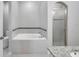 Bright bathroom with a soaking tub, glass enclosed shower, and granite vanity at 11878 Thicket Wood Dr, Riverview, FL 33579