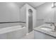 Bathroom featuring soaking tub, standing shower, and double vanity with granite countertop at 11878 Thicket Wood Dr, Riverview, FL 33579