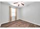 Bedroom with hardwood flooring, a ceiling fan, and a window at 11878 Thicket Wood Dr, Riverview, FL 33579