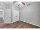 This is a clean bedroom that has a ceiling fan, hardwood floor, and bright white trim and blinds at 11878 Thicket Wood Dr, Riverview, FL 33579