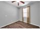 Bedroom with hardwood flooring, a ceiling fan, and a window at 11878 Thicket Wood Dr, Riverview, FL 33579
