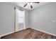 This is a clean bedroom that has a ceiling fan, hardwood floor, and bright white trim and blinds at 11878 Thicket Wood Dr, Riverview, FL 33579
