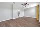 Bedroom featuring wood floors, neutral colored walls and access to bathroom via an arched doorway at 11878 Thicket Wood Dr, Riverview, FL 33579