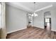 Spacious dining room featuring modern light fixture and views to other rooms at 11878 Thicket Wood Dr, Riverview, FL 33579