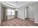 Bright dining area with modern light fixture and large window at 11878 Thicket Wood Dr, Riverview, FL 33579