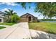 Lovely home with a long driveway, well-kept lawn, and a serene lake view in a peaceful community at 11878 Thicket Wood Dr, Riverview, FL 33579