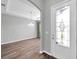 Elegant foyer featuring hardwood floors, a chandelier, and an inviting view into the adjacent living area at 11878 Thicket Wood Dr, Riverview, FL 33579
