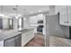 Open concept kitchen with granite island, stainless appliances, and wood flooring at 11878 Thicket Wood Dr, Riverview, FL 33579