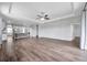 Open-concept living room featuring tray ceiling, wood floors and easy access to kitchen and dining area at 11878 Thicket Wood Dr, Riverview, FL 33579