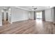 Spacious living room with wood floors, tray ceiling with fan, and sliding doors to outdoor patio at 11878 Thicket Wood Dr, Riverview, FL 33579