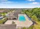 Community pool with lounge chairs and covered area surrounded by homes at 11878 Thicket Wood Dr, Riverview, FL 33579