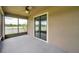 Cozy screened patio featuring a ceiling fan, providing access to the backyard and lake views at 11878 Thicket Wood Dr, Riverview, FL 33579