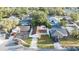 Aerial view of home with a well-maintained lawn, and surrounded by mature trees in quiet neighborhood at 11991 104Th Ave, Seminole, FL 33778
