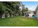 Expansive backyard offers lush greenery, a white privacy fence, and a covered patio area at 11991 104Th Ave, Seminole, FL 33778