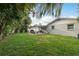 Spacious backyard featuring well-manicured lawn and covered outdoor seating area at 11991 104Th Ave, Seminole, FL 33778