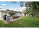 Spacious backyard featuring a covered patio, well-maintained lawn, and lush landscaping at 11991 104Th Ave, Seminole, FL 33778