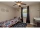 Cozy bedroom featuring a ceiling fan, plush rug, and a window with dark curtains, perfect for a room at 11991 104Th Ave, Seminole, FL 33778