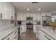 Modern kitchen featuring white cabinets, granite countertops, and stainless steel appliances at 11991 104Th Ave, Seminole, FL 33778