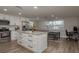 Bright kitchen with white cabinets, stainless steel appliances, and a center island with barstool seating at 11991 104Th Ave, Seminole, FL 33778