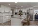 Bright kitchen featuring white cabinetry, stainless steel appliances, and a center island with seating at 11991 104Th Ave, Seminole, FL 33778