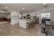 Open kitchen with white cabinets, an island with seating, and stainless steel appliances at 11991 104Th Ave, Seminole, FL 33778